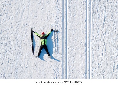 Skier cross-country skiing in snow forest. Winter competition, Aerial top view.