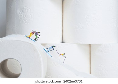 Skier descending on a white toilet paper roll, background white toilet paper rolls, miniature figures scene
​ - Powered by Shutterstock