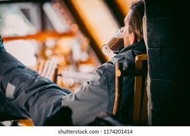 A Skier Drinking Cocoa In A Ski Lodge