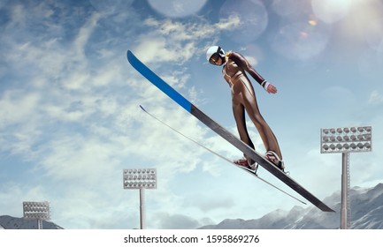 Skier in flight on ski jumping competition. on sunset. Winter sport.