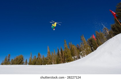 Skier Gets Big Air And Does A Radical Backflip On A Sunny Day With Blue Sky