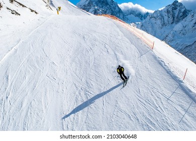 A skier going down the mountainside