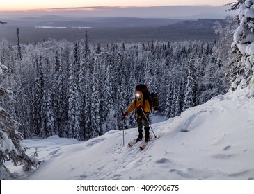 A Skier With A Headlamp In The Winter Hike At Night