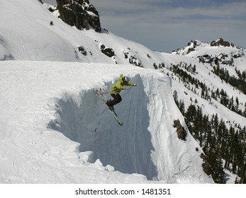 Skier Jumping Off A Cornice At A Lake Tahoe Ski Resort