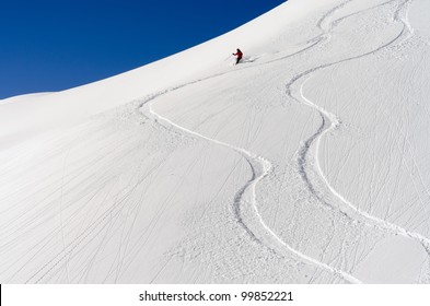 a skier makes his tracks in the deep powder snow