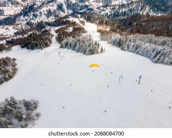 Skier Paraglider Above The Mountain Ski Slope Extreme Sport