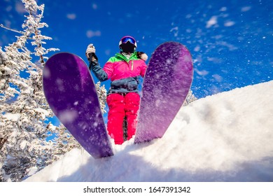 Skier is preparing for jump, lower angle of ski, blue sky winter forest.