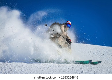 Skier rides beautifully in the mountains
Skier rides fast and snow flies