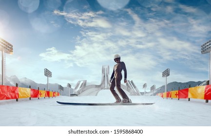 Skier in ski jumping competition on sunset. Winter sport.
