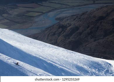 Skier Skiing Down A Face At Treble Cone New Zealand