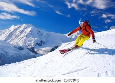 Skier Skiing Downhill In High Mountains, Matterhorn Area, Switzerland