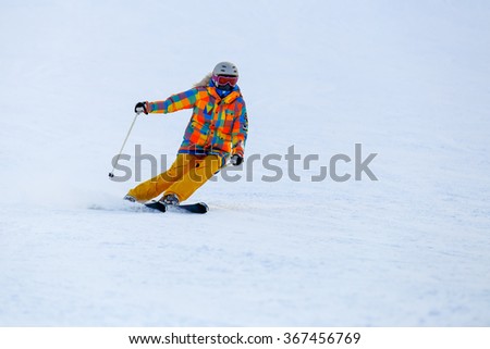 Skier skiing in fresh snow on ski slope
