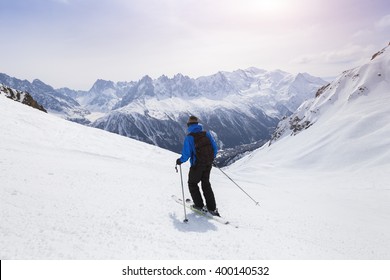 Skier Skiing On Red Slope In Alps Mountains Near Chamonix, France