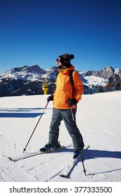 Skier Standing On The Ski Slope And Looking Somewhere