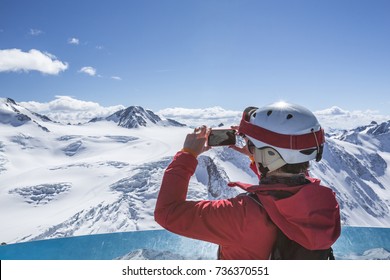 Skier take a smartphone photo at the summit - Powered by Shutterstock