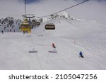 Skiers and chair lift in the Saint Moritz ski resort in the alps in Canton Graubunden in Switzerland