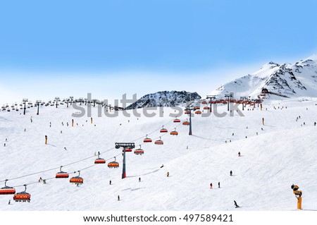 Skiers and chairlifts in Alpine ski resort in Solden in Otztal Alps, Tirol, Austria