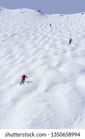 Skiers Descending The Steep Mogul Ski Hill Slope At A Mountain In Lake Louise In The Canadian Rockies Of Alberta, Canada.