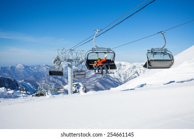 Skiers on the chairlift ropeway winter resort