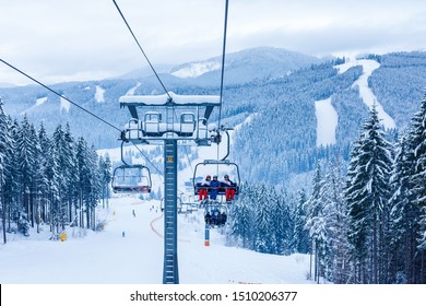 Skiers on chairlift at ski resort
