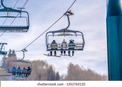 Skiers On Ski Lifts Against Sky In Park City Utah