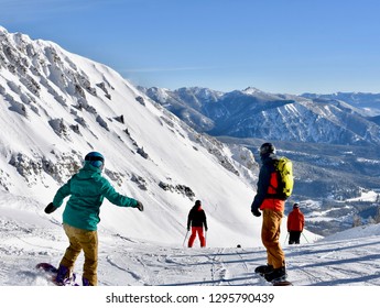 Skiers And Snowboarders Going Over The Edge At Big Sky Ski Resort, Montana