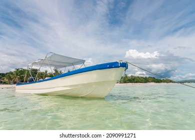 A Skiff Boat Docked In Shallow Waters At Dumaluan Beach In Panglao, Bohol. Low Angle Shot.