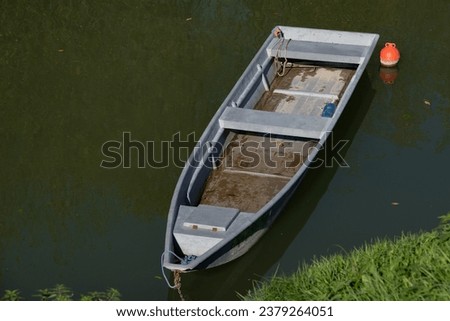 Skiff rowing boat with rainwater in the bottom.