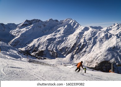 Skiier on slopes in the ski resort of St. Anton, Austria - December 2019 - beautiful snowy peaks - winter sports in Austria