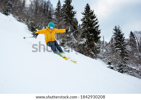A skiier is riding down the hill. Freeriding in Carpathian mountains.	