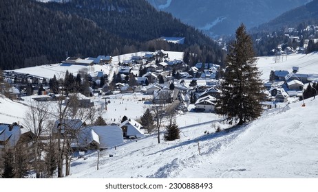 Skiing in Bad Kleinkirchheim, Carinthia - Austria. Winterview with houses, slopes and a blue ski.