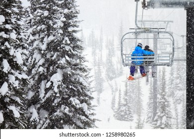 Skiing Couple On Chairlift