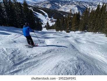 Skiing on sunny day at Vail Breckenridge ski resort in Colorado.