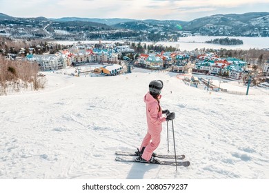 Skiing Woman. Alpine Ski - Skier Looking Mountain Village Ski Resort View Starting Skiing Downhill On Snow Covered Ski Trail Slope In Winter. Mont Tremblant, Quebec, Canada.