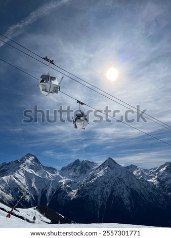 Skilift in front of a mountainview
