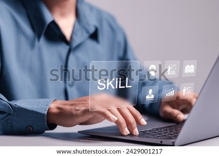 Skill concept. work performance is influenced by skills, abilities, and competence. Businessman using laptop with SKILL word and icons on virtual screen.