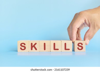 Skill Development Building And Investment And Learn New Skills Concept. Hand Stacking Wooden Blocks With Word Skills.