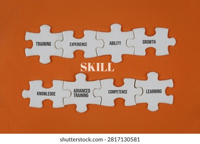 Skill Development Concept With Puzzle Pieces Labeled Training Experience Ability Growth Knowledge Learning Competence. illustrating competence and career growth. with an orange background.