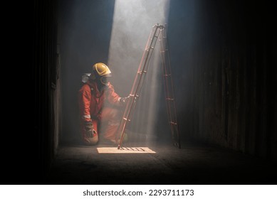 With skill and precision the firefighter ascends the ladder to assess the situation. - Shutterstock ID 2293711173