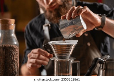 Skilled barista using the Kalita Wave dripper coffee maker to create a meticulously brewed cup of coffee - Powered by Shutterstock