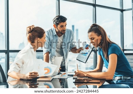 Skilled businessman present financial statistic at business meeting. Diverse business team working together, sharing marketing idea. Group of businesspeople discussion about business plan. Tracery.