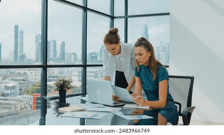 Skilled businesswoman look stress while discuss about financial strategy. Smart business team brainstorming, talking consulting sales plan, idea by using statistic document with tension. Tracery - Powered by Shutterstock