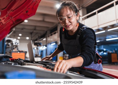 Skilled chinese mechanic using a laptop for diagnostics while working on a car engine in a professional auto repair shop - Powered by Shutterstock