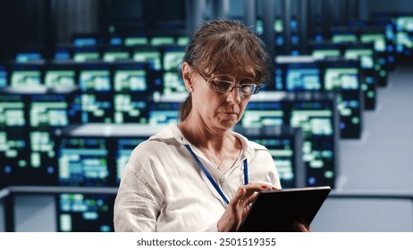 Skilled computer scientist in data center equipped to handle complex computing requirements, doing regular upgrades to server clusters, increasing processing power to prevent malfunctions