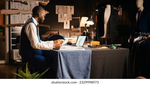 Skilled craftsman studying sketches in tailoring atelier, using outlines of clothes before creating modern clothing line. Male designer manufacturing handmade clothes, fashion concept. - Powered by Shutterstock