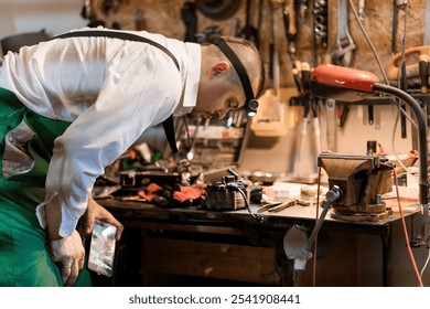 Skilled Craftsman Working in a Workshop Surrounded by Tools and Equipment. - Powered by Shutterstock