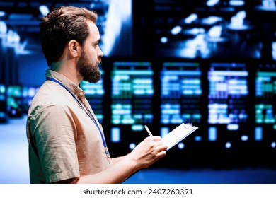 Skilled domputer scientist setting up server hub advanced firewalls, intrusion detection systems and security updates. Precise cybersecurity expert preventing hacking, malware, and phishing attacks - Powered by Shutterstock