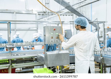skilled engineer evaluates operational settings on control equipment in food production factory, ensuring compliance with quality assurance protocols and maintaining smooth manufacturing operations.