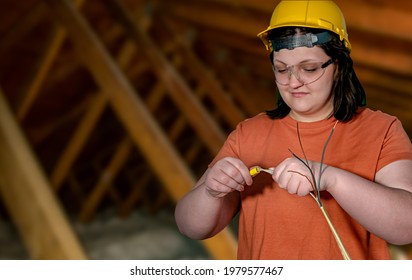 Skilled Female Electrician Connecting Wires For For Home Remodel Wiring. Skilled Woman Occupation	