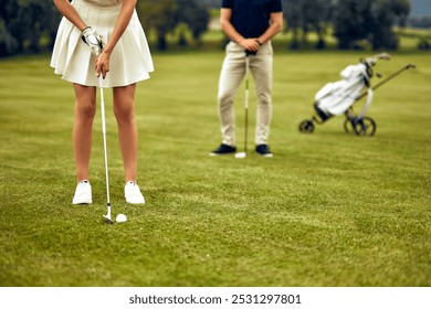 A skilled female golfer carefully lines up her putt on a beautifully lush green, with her supportive companion watching closely, creating a captivating scene for golf enthusiasts all around the world - Powered by Shutterstock